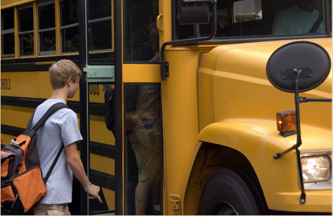 Teen getting on school bus