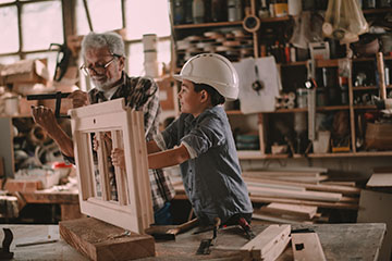 Grandfather and child building a project
