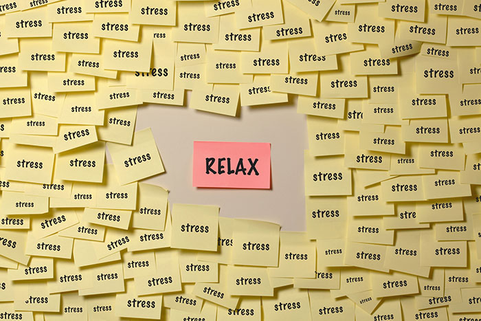Relax sticky note surrounded by stress stickey notes.