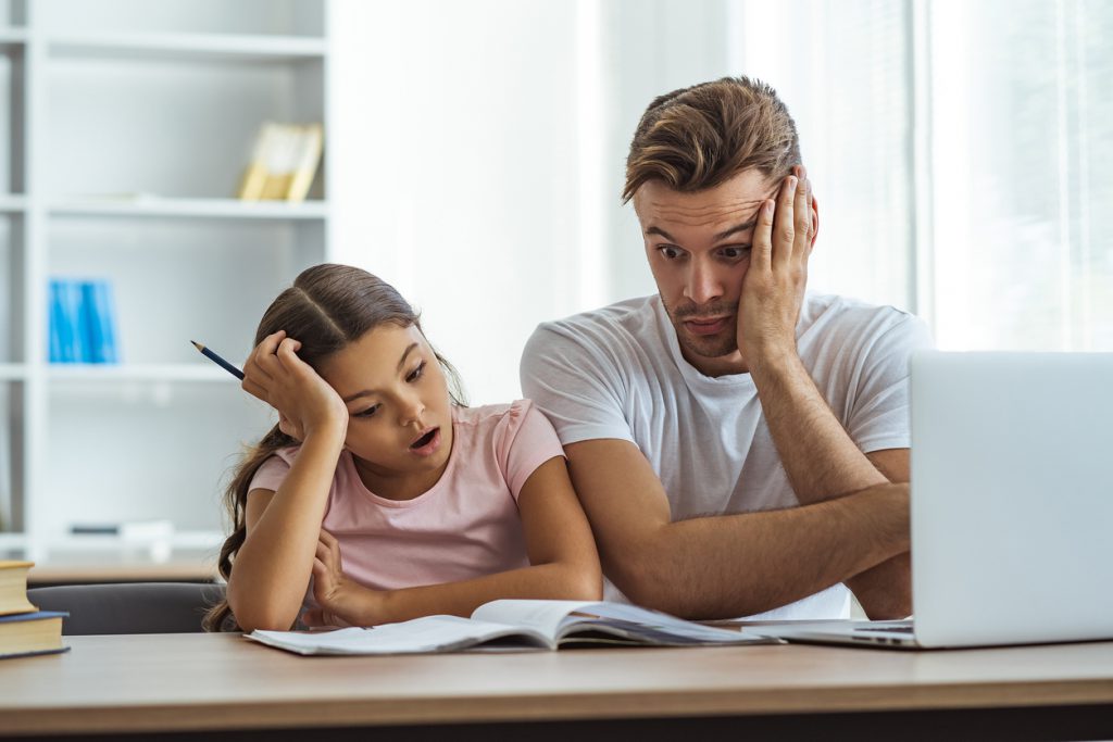 Dad and daughter having a hard time with homework
