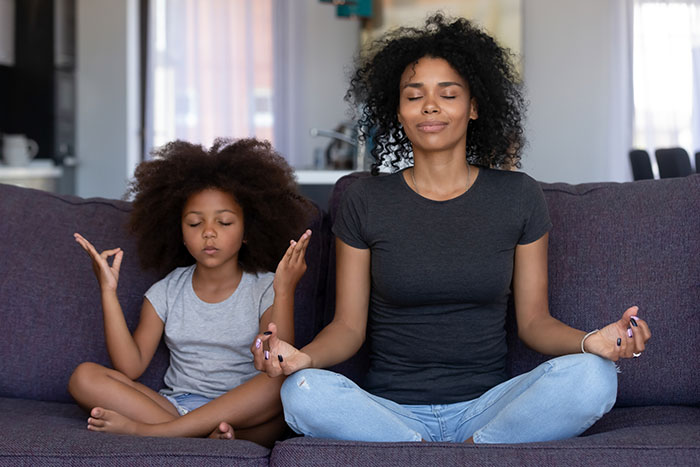 Mom and daughter practicing Yoga