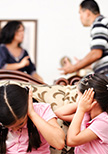 A couple fighting with their kids trying not to listen