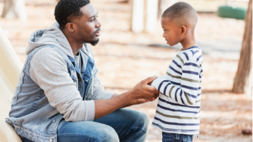 Image of a father talking to his young son