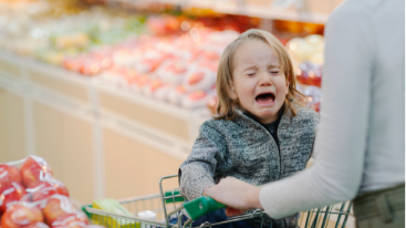 Image of a little girl throwing a tantrum while at the grocery store.